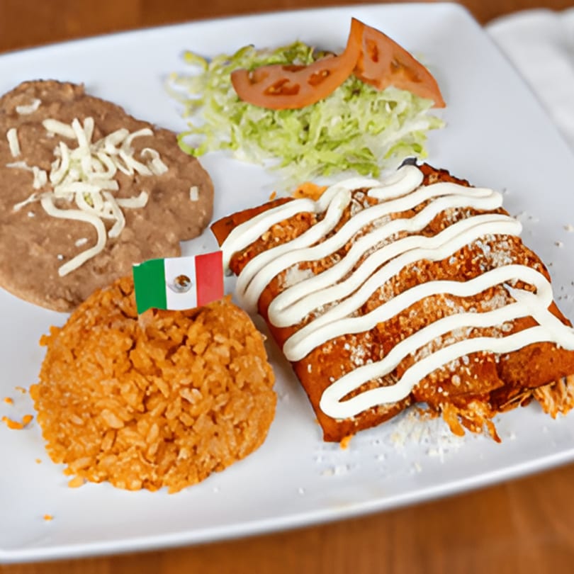 Mexican enchiladas with rice, refried beans, and a side salad, garnished with a Mexican flag.